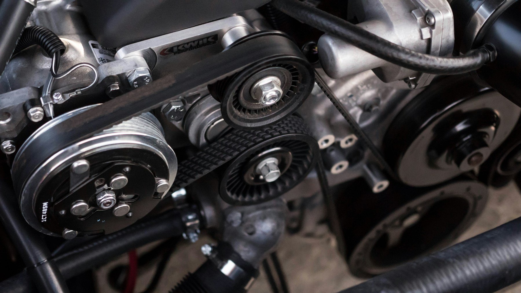 Close-up of a car engine and auxiliary belt
